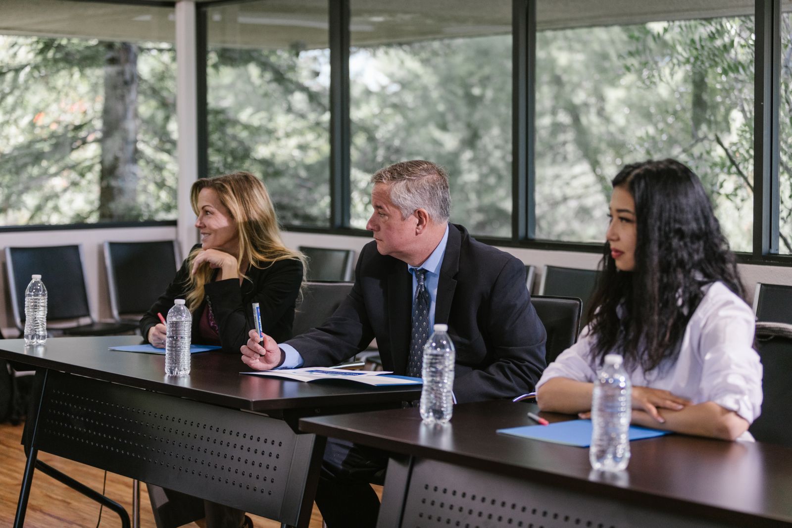 A diverse group of senior professionals engaged in a leadership meeting